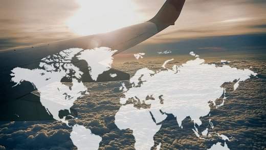 Aereo in volo al tramonto con mappa del mondo in sovraimpressione