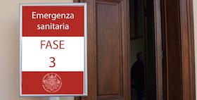 foto Fase 3 cartello con dicitura su sfondo rosso e portone marrone aperto chiosco uniss